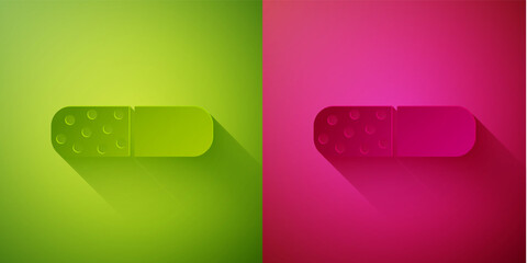 Paper cut Vitamin complex of pill capsule icon isolated on green and pink background. Healthy lifestyle. Paper art style. Vector.
