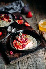 Oatmeal with figs, chia, raspberries and strawberries. Healthy Breakfast