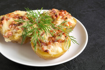 Hot baked stuffed potatoes with cheese, bacon, parsley.