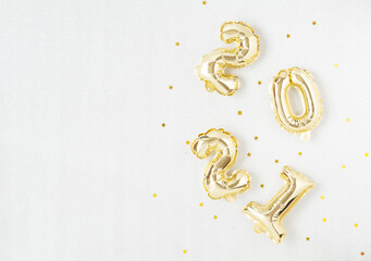 Happy New year 2021 celebration. Gold foil balloons numeral 2021 on silver background.
