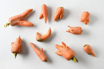 Abnormal ugly organic carrots on white background. View from above.