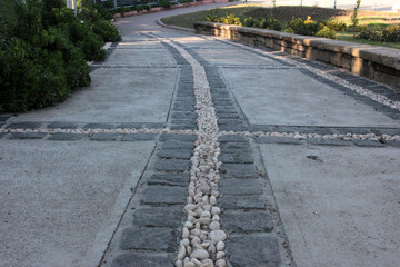 Fototapeta na wymiar decorative stone pavement road in the park