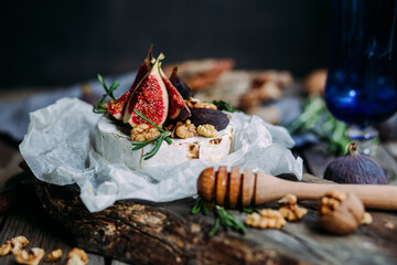 baked Camembert cheese with figs, nuts, honey and rosemary