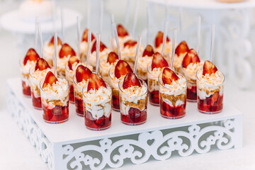 candy bar on wedding reception. baskets decorated with cream and