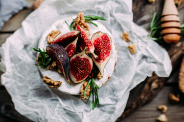baked Camembert cheese with figs, nuts, honey and rosemary