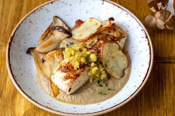 Pan fried halibut with mushroom velute, hazelnut pesto and potato crisps