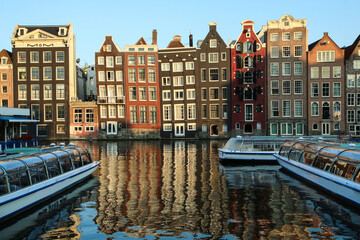 The colorful crooked houses by the canal in the Dutch city of Amsterdam. 