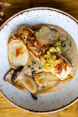 Pan fried halibut with mushroom velute, hazelnut pesto and potato crisps