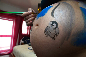 Belly painting on a pregnant woman