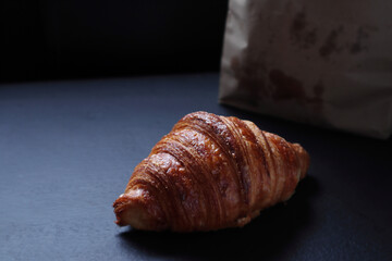 croissants on the wooden black table as breakfast in the morning in the cafe with family 