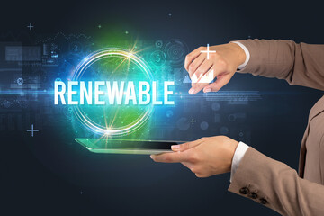 Close-up of a touchscreen with RENEWABLE inscription, new technology concept