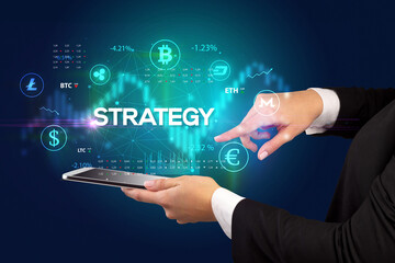 Close-up of a touchscreen with STRATEGY inscription, business opportunity concept