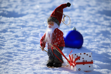 santa Claus with the gift on the snow