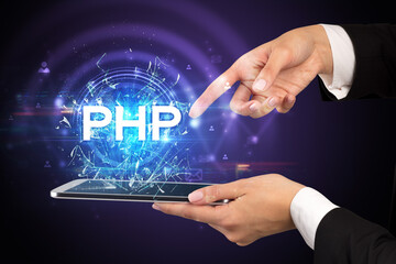 Close-up of a touchscreen with PHP abbreviation, modern technology concept