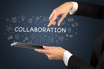 Close-up of a touchscreen with COLLABORATION inscription, social media concept