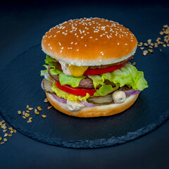 Big burger on the black stone tray 