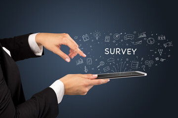 Close-up of a touchscreen with SURVEY inscription, social media concept