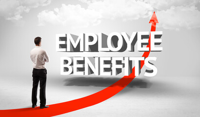 Rear view of a businessman standing in front of EMPLOYEE BENEFITS inscription, successful business concept