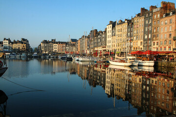 The nice and famous city of Honfleur in Normandy in France during the nice morning . The calm city...