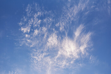 Naklejka na ściany i meble Blue sky with flying clouds as a background.