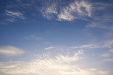 White clouds and blue sky in sunlight.