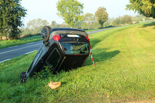 Abandoned car in the ditch after the traffic accident. Lying on the roof. 