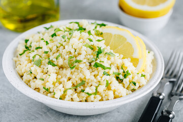 Lemon Herb Couscous in bowl on gray background