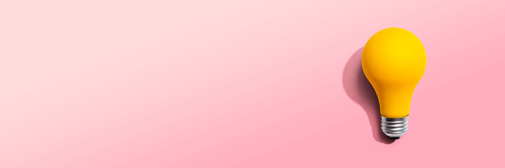 Yellow light bulb - flat lay from above