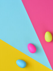 Easter layout made with Easter eggs and colorful background. Spring holidays concept. Creative copy space. Flat lay.
