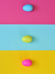 Easter layout made with Easter eggs and colorful background. Spring holidays concept. Creative copy space. Flat lay.