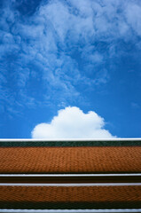 White cloud in blue sky with Thailand's traditional architecture.