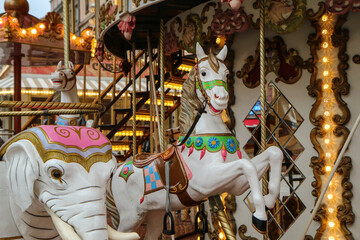 The detail of the smiling horse statue on the old carousel.  