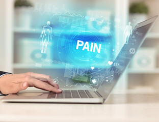 Doctor working a health check with PAIN inscription, recording medical test results