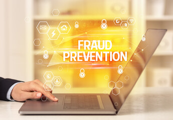 FRAUD PREVENTION inscription on laptop, internet security and data protection concept, blockchain...