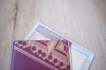 Kuwait Quarter Dinar Partially Inside a Sweden Passport