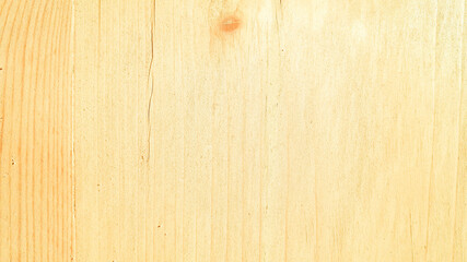 The background of a wooden surface in a warm shade of yellow.