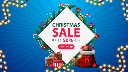 Christmas sale, discount banner with diamond-shaped frame of Christmas tree branches and garlands around offer, pink button and garland frame on blue background