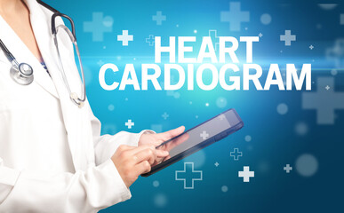 doctor writes notes on the clipboard with HEART CARDIOGRAM inscription, first aid concept