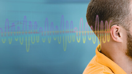 Hearing test, sound waves showing modern deafness diagnostic over male ear with BTE hearing aid