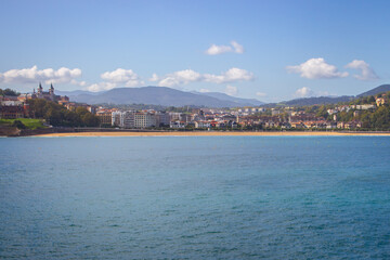 San Sebastian landmark, view from the sea. Famous beach called La Concha in San Sebastian, Spain. Scenic bay of Biscay. Aerial view of Biscayen seacoast and mountains on background. Seaside and city.