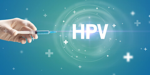 Obraz na płótnie Canvas Syringe needle with virus vaccine and HPV abbreviation, antidote concept