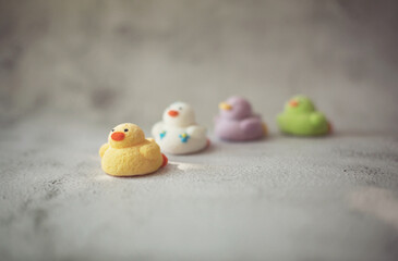 
marshmallows in the form of ducks of different colors