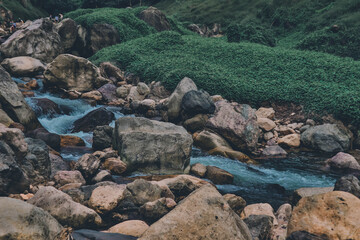 Fototapeta na wymiar River flows over rocks in this beautiful scene