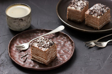 Chocolate cake with sour cream, served with coffee.