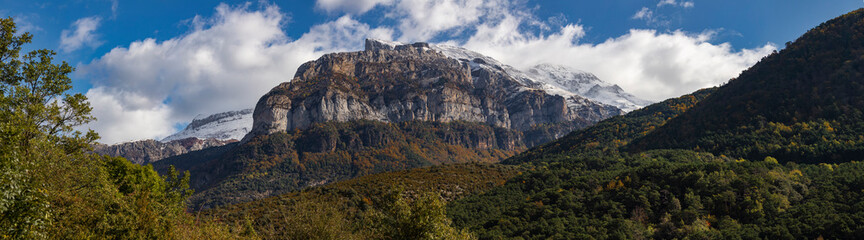 Panoramic autumn view of the mountains and the Aguerri and Caznarez bands, in the Aragonese Pyrenees, in the Selva de Oza, Hecho valley, Spain.