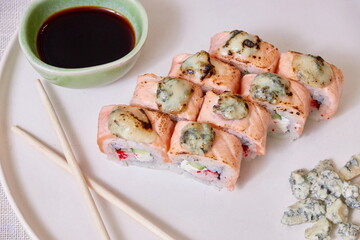 Fresh sushi rolls on a plate, top view
