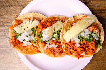 Tacos al pastor with corn tortillas. Mexican food. Mexican food concept on wooden table. Traditional Mexican food