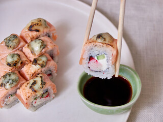 Taking Fresh sushi with chopsticks