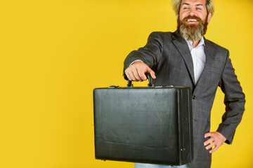 Hipster bearded face hold briefcase with bribe. Businessman run away business case. Happy smiling worker. Business man formal suit carries briefcase. Illegal deal business. Cheerful sales manager