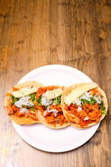 Tacos al pastor with corn tortillas. Mexican food. Mexican food concept on wooden table. Traditional Mexican food